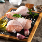 Raw chicken meat legs with spices, herbs and olive oil