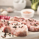 close-up-raw-steaks-with-veggies