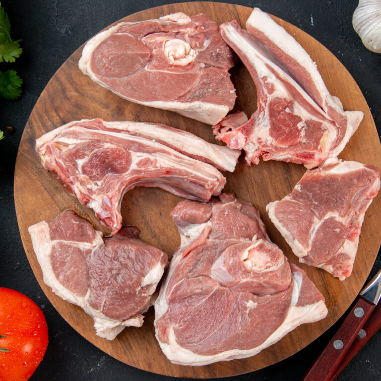 top-view-fresh-meat-slices-raw-meat-with-greens-tomatoes-dark-kitchen-meal-food-cow-food-dish-salad-barbecue-animal